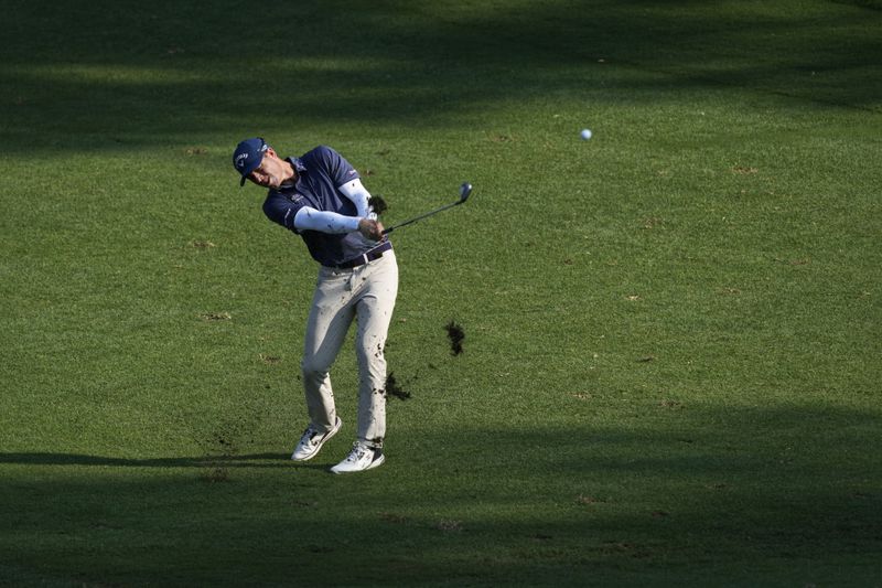 Max Greyserman hits to the ninth green during the final round of the Wyndham Championship golf tournament in Greensboro, N.C., Sunday, Aug. 11, 2024. (AP Photo/Chuck Burton)