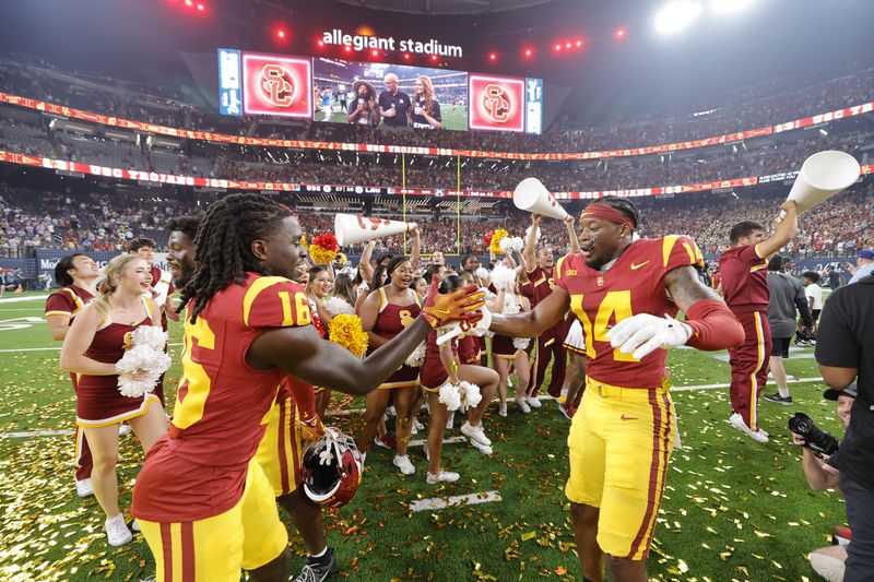 Southern California cornerbacks Prophet Brown (16) and Jacobe Covington (14) celebrate their team's win over LSU in an NCAA college football game Sunday, Sept. 1, 2024, in Las Vegas. (AP Photo/Steve Marcus)