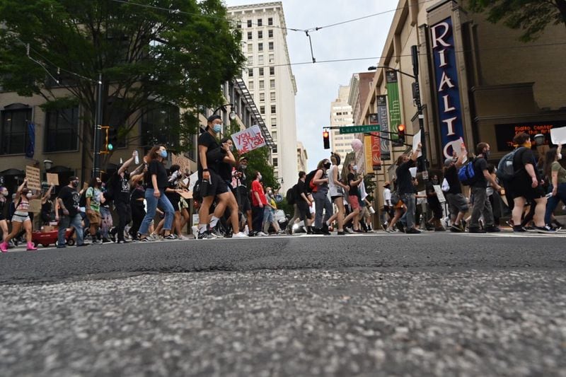 Large groups remain marching and protesting in downtown Atlanta as the city's 8 p.m. curfew approaches Friday.