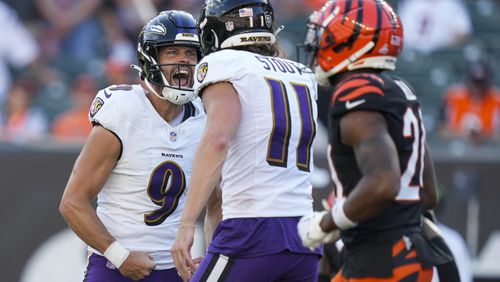 Baltimore Ravens kicker Justin Tucker, left, reacts with holder Jordan Stout after booting the game-winning field goal in overtime of an NFL football game, Sunday, Oct. 6, 2024, in Cincinnati. The Ravens won 41-38 in overtime. (AP Photo/Carolyn Kaster)