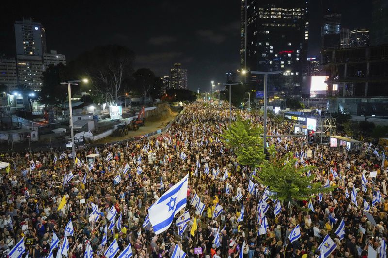 People protest against Prime Minister Benjamin Netanyahu's government and call for the release of hostages held in the Gaza Strip by the Hamas militant group, in Tel Aviv, Israel, Saturday, Sept. 7, 2024. (AP Photo/Ariel Schalit)