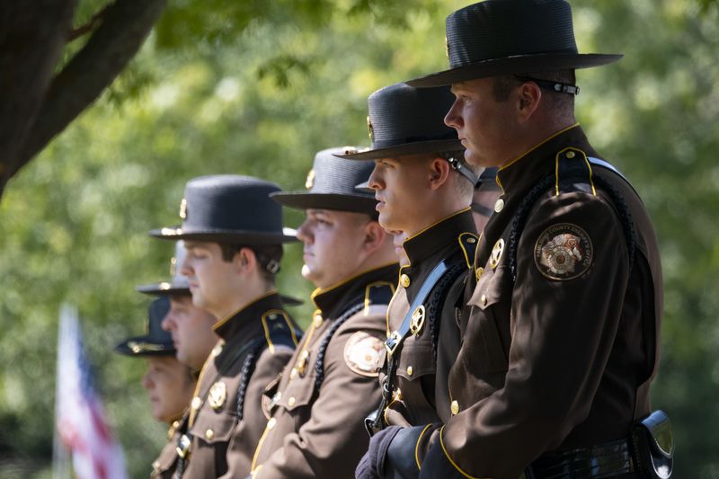 Members of the Paulding County Sheriff’s Office line up before firing a salute during the funeral for Deputy Brandon Cunningham in Dallas on Friday. (Ben Gray / Ben@BenGray.com)