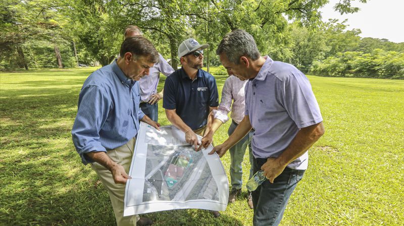 Rawson Haverty, a partner with Forever Young, and Dave Geist, the developer of the property, examine a rendering of the proposed aquaponics farm on the Clayton County site. (Courtesy photo)