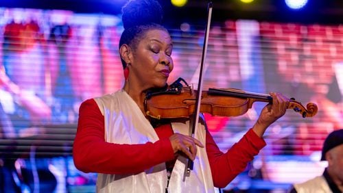 Violinist Karen Briggs performs Saturday at The Stockbridge Amphitheater. Briggs' Contempo Orchestra was the main attraction at a star-filled show that featured Oleta Adams, Phil Perry and Regina Belle. (Ben Hendren for the Atlanta Journal-Constitution)