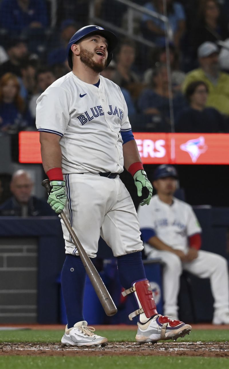 Toronto Blue Jays' Alejandro Kirk (30) reacts to striking out in the ninth inning of a baseball game against the Philadelphia Phillies in Toronto on Tuesday, Sept. 3, 2024. (Jon Blacker/The Canadian Press via AP)