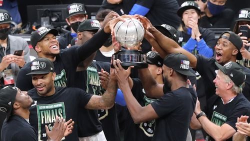 The Milwaukee Bucks celebrate winning the NBA Eastern Conference Finals with the trophy after defeating the Atlanta Hawks 118-107 in game 6 on Saturday, July 3, 2021, in Atlanta.   “Curtis Compton / Curtis.Compton@ajc.com”