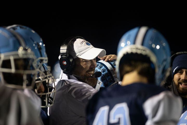 Cambridge Head Coach Craig Bennett hugs players during a GHSA high school football game between Cambridge and South Paulding at Cambridge High School in Milton, GA., on Saturday, November 13, 2021. (Photo/Jenn Finch)