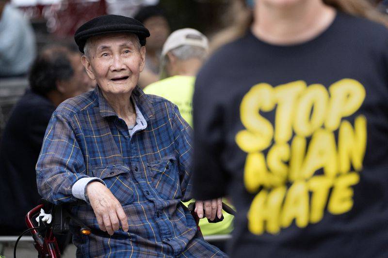 Li Zhou watches a remembrance ceremony for Vincent Chin in Chinatown, Sunday, June 23, 2024, in Boston. Over the weekend, vigils were held across the country to honor the memory of Chin, who was killed by two white men in 1982 in Detroit. (AP Photo/Michael Dwyer)