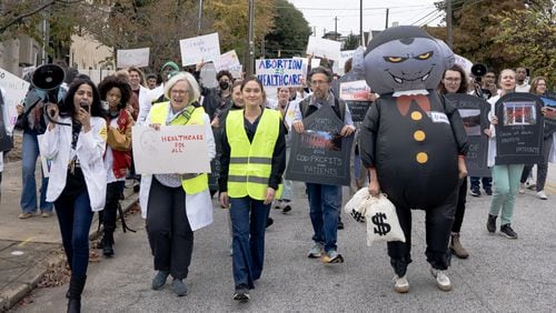 Protestors march to expand access to Medicaid in Georgia in front of Wellstar's Atlanta Medical Center which used to be an Emory Hospital before it was shut down years ago in Atlanta on Sunday, November 12, 2023. (Olivia Bowdoin for The Atlanta Journal-Constitution)