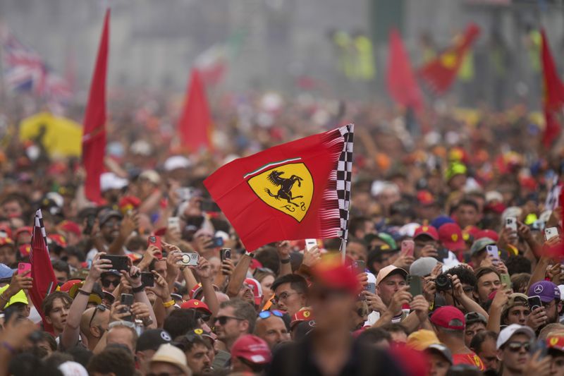 Supporters celebrate victory of Ferrari driver Charles Leclerc of Monaco after the Formula One Italian Grand Prix race at the Monza racetrack, in Monza, Italy, Sunday, Sept. 1, 2024. (AP Photo/Luca Bruno)