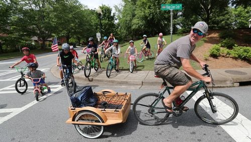 051920 Smyrna: Jerry Luzar leads a daily Smyrna PE class for children whose parents are tied of them sitting at home starting out on their daily 5 to 7 mile bike ride from the Smyrna Community Center on Tuesday, May 19, 2020, in Smyrna.   Curtis Compton ccompton@ajc.com