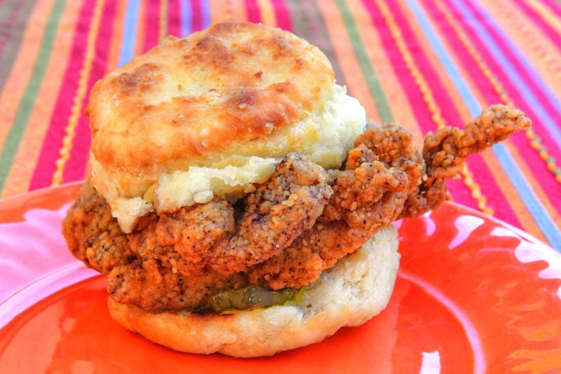 Bomb's Glori-Fried chicken biscuit features a thick, juicy cutlet of fried chicken with a few bread and butter pickles. Chris Hunt for The Atlanta Journal-Constitution 