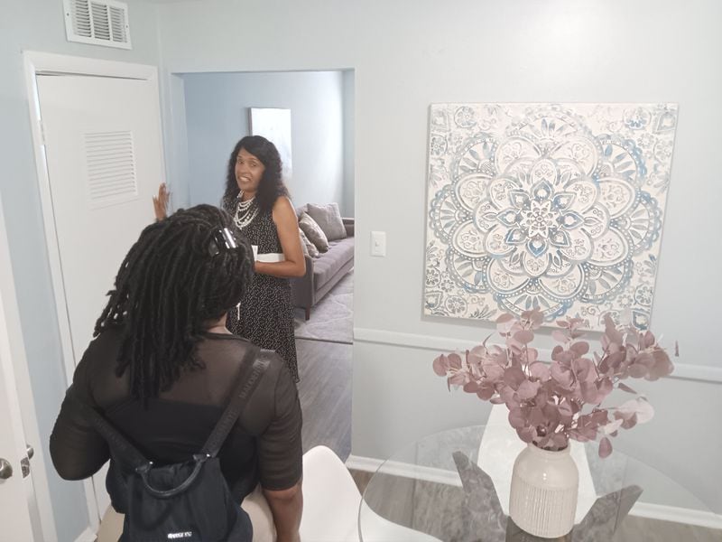 Malika Staar of The Power of Two Marketing Services shows prospective tenant Kimberly Hayes (foreground) around a model unit in Polaris at East Point apartments on Aug. 26, 2024.