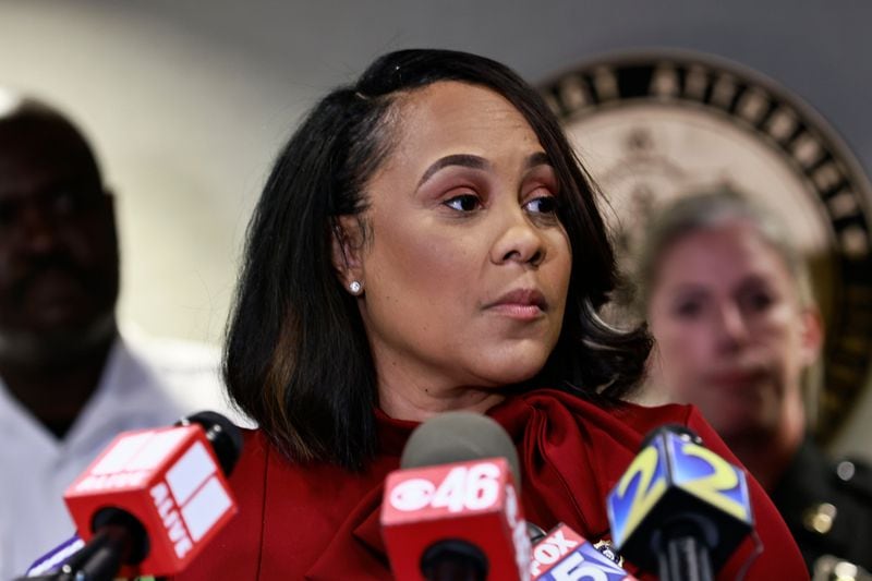 In this photo from  Aug. 29, 2022, surrounded by Fulton County law enforcement officials, District Attorney Fani Willis speaks during a news conference about the RICO indictment in the celebrity home invasion ring. (Natrice Miller/The Atlanta Journal-Constitution/TNS)