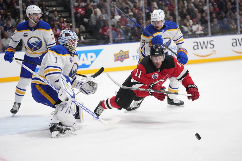 New Jersey Devils' Stefan Noesen, right, and Buffalo Sabres' goaltender Ukko-Pekka Luukkonen battle for the puck during the NHL hockey game between Buffalo Sabres and New Jersey Devils, in Prague, Czech Republic, Friday, Oct. 4, 2024. (AP Photo/Petr David Josek)