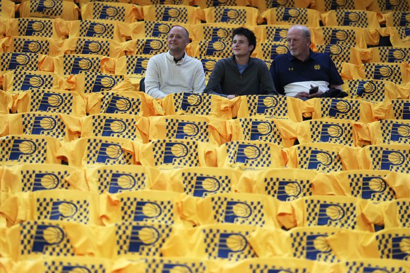 Fans watch players warm up before Game 3 of the NBA Eastern Conference basketball finals between the Indiana Pacers and the Boston Celtics, Saturday, May 25, 2024, in Indianapolis. (AP Photo/Michael Conroy)