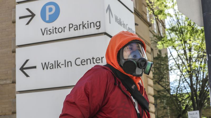 Van Wimberly walks to his MRI appointment at Grady Memorial Hospital in Atlanta on Wednesday, April 1, 2020, wearing a respirator mask given to him by his mother. JOHN SPINK/JSPINK@AJC.COM