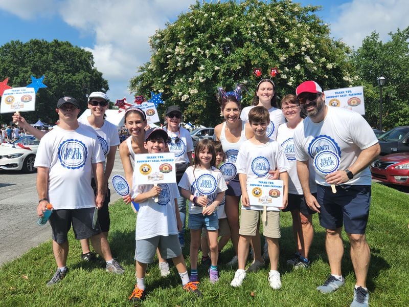 Erin Stieglitz and her Bagel Rescue crew pose during the Dunwoody July 4th Parade this year. Bagel Rescue supports hunger relief in metro Atlanta by picking up leftover food from bagel shops and distributing these donations to food pantries. Photo contributed by Erin Stieglitz