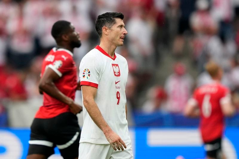 Poland's Robert Lewandowski reacts after the third goal of Austria during a Group D match between Poland and Austria at the Euro 2024 soccer tournament in Berlin, Germany, Friday, June 21, 2024. (AP Photo/Ebrahim Noroozi)
