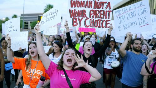 FILE - Protesters join thousands marching around the Arizona Capitol in Phoenix, protesting the U.S. Supreme Court's decision to overturn Roe v. Wade, June 24, 2022. (AP Photo/Ross D. Franklin, File)