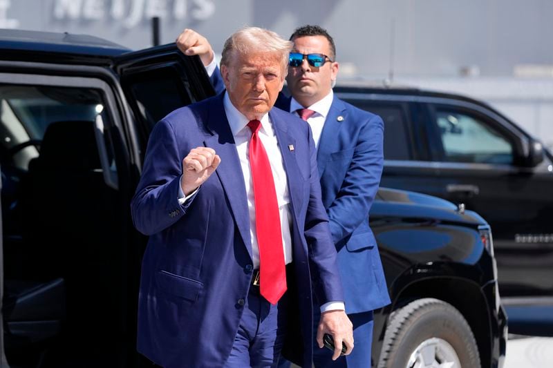 Republican presidential nominee former President Donald Trump gestures as he arrives at Harry Reid International Airport to board a plane after a campaign trip, Saturday, Sept.14, 2024, in Las Vegas. (AP Photo/Alex Brandon)