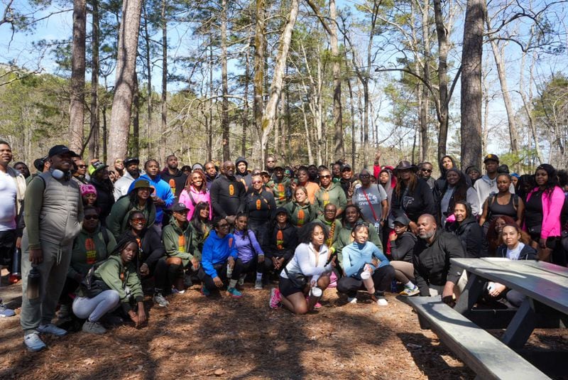 Big Bank poses in the center of a group of hikers joining one of his "Hik'n Wit Bank" events.