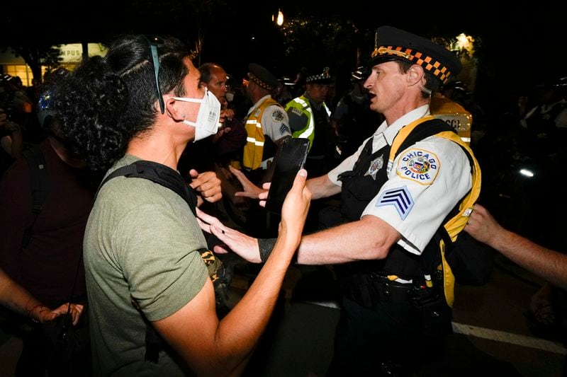 Police move protesters during a demonstration near the Democratic National Convention Thursday, Aug. 22, 2024, in Chicago. (AP Photo/Julio Cortez)