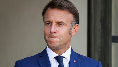 French President Emmanuel Macron gestures at the Elysee Palace as French left-wing coalition accuses Emmanuel Macron of denying democracy after he has rejected the New Popular Front's candidate to form a new government following last month's inconclusive election, Tuesday, Aug. 27, 2024 in Paris. (AP Photo/Thomas Padilla)