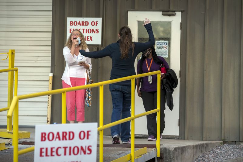 A group celebrates outside the Chatham County Board of Elections Annex building after officials said they have finished counting 99 percent of the ballots in Savannah, Ga. in November 2020. (Stephen B. Morton/AJC)