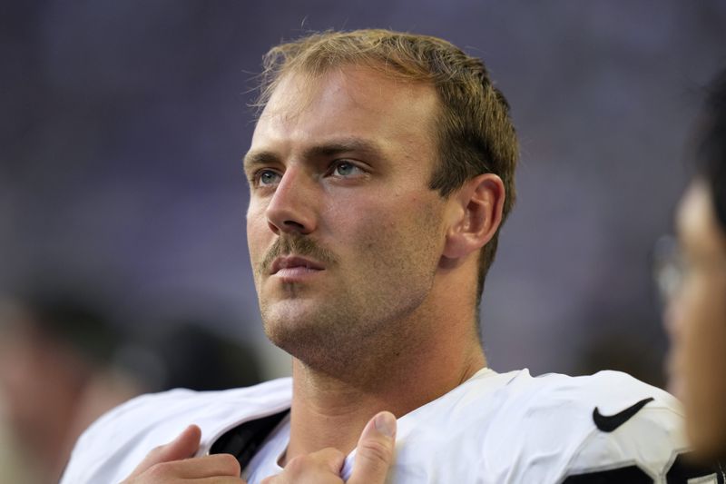 Las Vegas Raiders tight end Brock Bowers watches from the sideline during the second half of an NFL preseason football game against the Minnesota Vikings, Saturday, Aug. 10, 2024, in Minneapolis. (AP Photo/Charlie Neibergall)