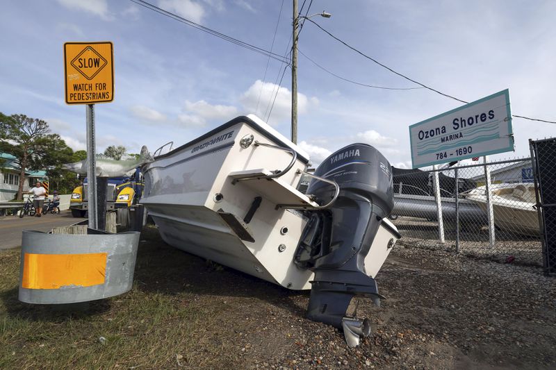 Boats sit on the drive and roadways after being pushed by floodwaters from Hurricane Helene at the Ozona Shores Marina on Friday, Sept. 27, 2024, in Palm Harbor, Fla. (AP Photo/Mike Carlson)