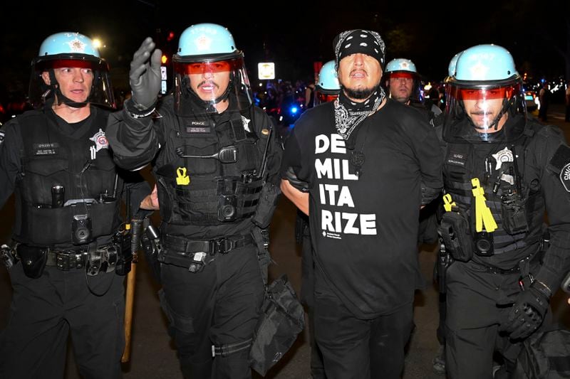 Police move protesters during a demonstration near the Democratic National Convention Thursday, Aug. 22, 2024, in Chicago. (AP Photo/Noah Berger)