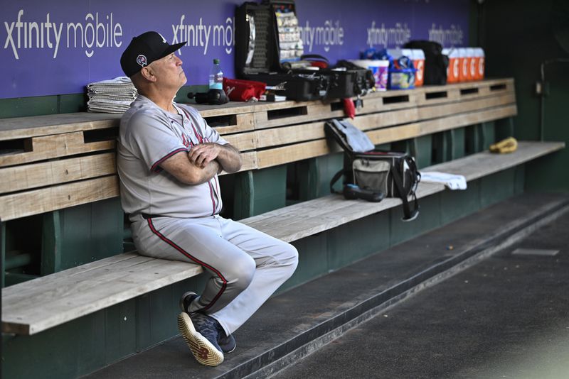 Atlanta Braves manager Brian Snitker contemplates things in the dugout.