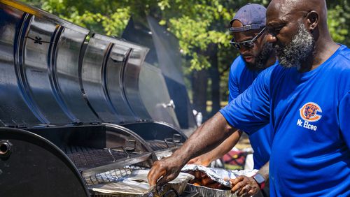 A team of vendors grill burgers and hotdogs at the Pure Heat Community Festival in Piedmont Park on Sunday, Sept. 1, 2024. (Olivia Bowdoin for the AJC). 