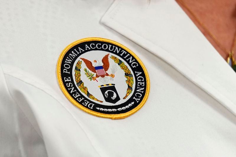 A Defense POW/MIA Accounting Agency patch is seen on the jacket of forensic anthropologist Carrie Brown in a lab at Offutt Air Force Base, Monday, May 20, 2024, in Bellevue, Neb. Generations of American families have grown up without ever knowing exactly what happened to their loved ones who served in the military. But a lab tucked away above the bowling alley on Offutt Air Force Base in the Omaha suburbs and a sister lab in Hawaii that are part of the federal DPAA are steadily answering those lingering questions and offering about 200 families a year the chance to honor their relatives with a proper burial. (AP Photo/Charlie Neibergall)