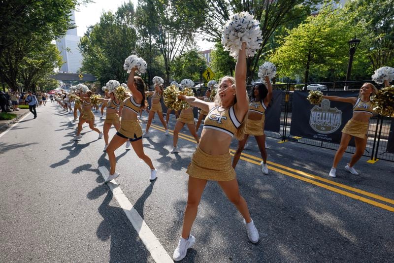 Georgia Tech cheerleaders entertain the crowd before the team arrives.  DJ Envy held the first pregame concert at Georgia Tech’s new "Helluva Block Party".  North Avenue was closed before the football game vs South Carolina State for the event in Atlanta on Saturday, September 9, 2023.   (Bob Andres for the Atlanta Journal Constitution)