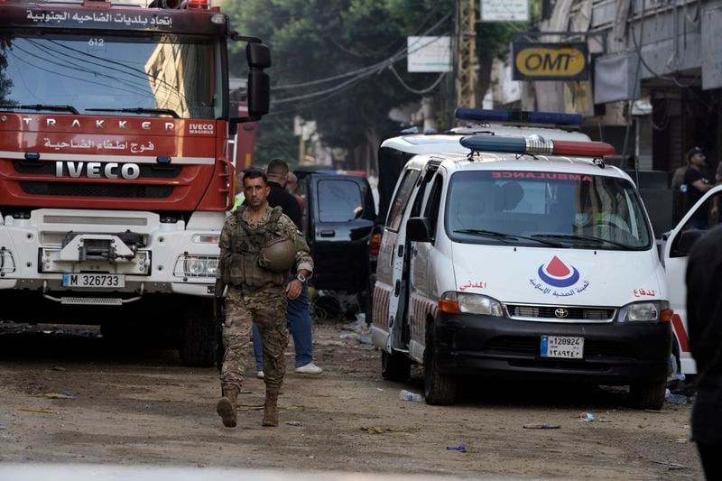 A Lebanese soldier walks near an ambulance an a firefighter truck, securing the area a day after an Israeli missile strike in Beirut's southern suburbs, Saturday, Sept. 21, 2024. (AP Photo/Bilal Hussein)