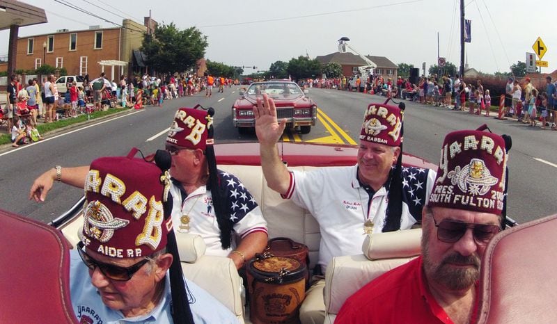 Aug 3, 2013 - Alpharetta - Richard Burke (back right), rides in a vintage Cadillac in the Old Soldiers Day Parade in Alpharetta in 2013.  BOB ANDRES / BANDRES@AJC.COM