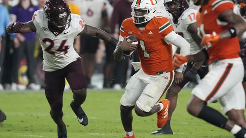 Miami quarterback Cam Ward (1) runs for a touchdown during the second half of an NCAA college football game against Virginia Tech , Friday, Sept. 27, 2024, in Miami Gardens, Fla. (AP Photo/Marta Lavandier)