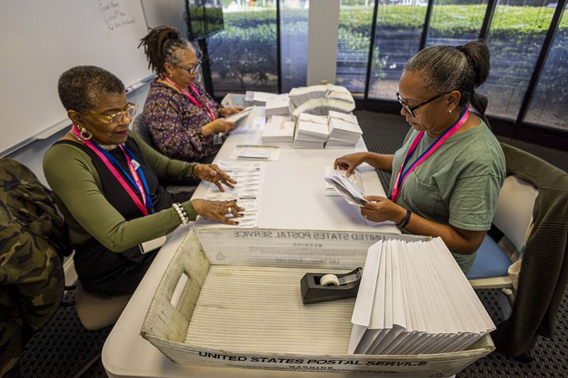 Left to right; Carol Hamilton, Cristo Carter and Cynthia Huntley prepare ballots at the Mecklenburg County Board of Elections in Charlotte, N.C., Thursday, Sept. 5, 2024. (AP Photo/Nell Redmond)