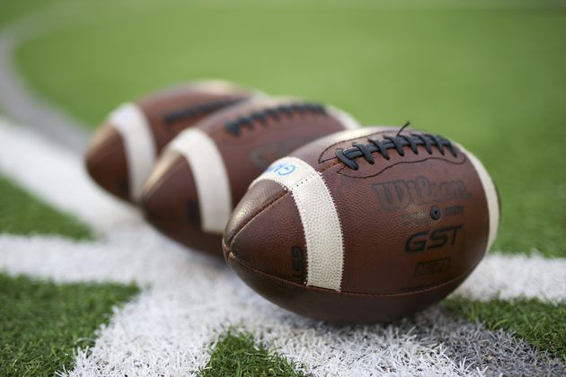 Three footballs are shown before the game between Peachtree Ridge and North Gwinnett at North Gwinnett high school, Friday, October 13, 2023, in Suwanee, Ga. (Jason Getz / Jason.Getz@ajc.com)