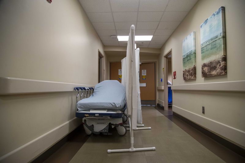 A makeshift emergency bed is curtained off in a hallway of the emergency room at Tanner Health System's hospital in Carrollton on Thursday. (Alyssa Pointer / Alyssa.Pointer@ajc.com)