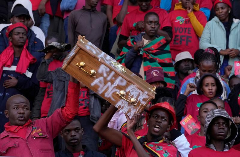 Supporters of the Economic Freedom Fighters (EFF), with a mock coffin representing the ruling African National Congress, attend a final election rally in Polokwane, South Africa, Saturday, May 25, 2024. South African will vote in the 2024 general elections May 29. (AP Photo/Themba Hadebe)