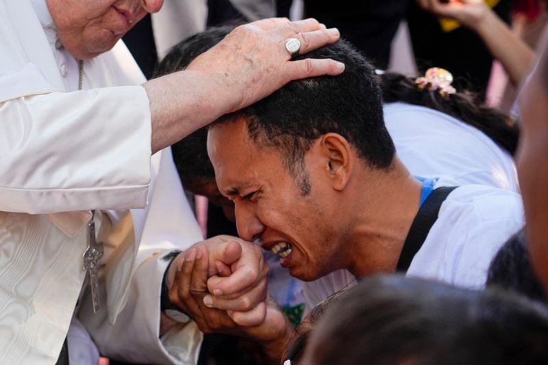 Pope Francis consoles a person during a visit at the 'Irmas ALMA' (Sisters of the Association of Lay Missionaries) School for Children with Disabilities in Dili, East Timor, Tuesday, Sept. 10, 2024. Pope Francis has indirectly acknowledged the abuse scandal in East Timor involving its Nobel Peace Prize-winning independence hero Bishop Carlos Filipe Ximenes Belo. (AP Photo/Gregorio Borgia)