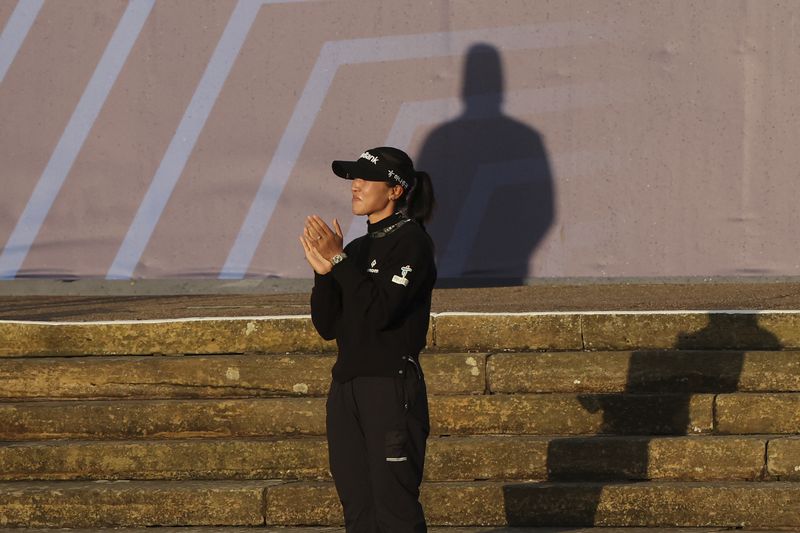 Lydia Ko, of New Zealand, the new Champion golfer applauds the leading amateur Lottie Woad of England during presentation ceremony for the Women's British Open golf championship, in St. Andrews, Scotland, Sunday, Aug. 25, 2024. (AP Photo/Scott Heppell)