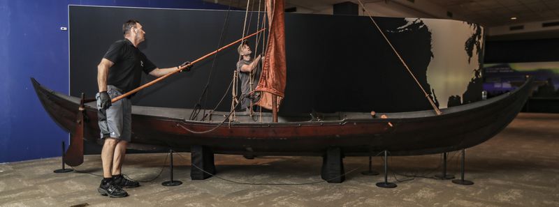 Members of MuseumsPartner Manfred Wittman (left) and Trent Rucker (right) put the finishing touches on a full-size replica of a Viking ship at Fernbank Museum of Natural History for "Vikings: Warriors of the Sea." (John Spink / John.Spink@ajc.com) 

