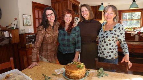 Asheville, N.C., culinarians Ashley English (from left), Ashley Capps, Susannah Gebhart and Barbara Swell recently spent an afternoon in Swell’s kitchen baking and assembling an apple stack cake, a traditional Appalachian dessert of thick dried apple filling spread between layers of sorghum-sweetened cake. Although the women are longtime friends, they had never all cooked together. TYSON HORNE / TYSON.HORNE@AJC.COM