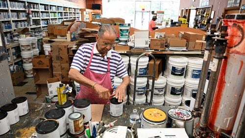 Thomas Portis  prepares to mix paint at Southwest Paint and Decorating, Thursday, July 10, 2024 in Atlanta. The Southwest Paint and Decorating Center on Ralph David Abernathy Blvd. has remained open for five decades since Portis purchased the business. He and his family have kept it afloat through hardships over the years like the COVID-19 pandemic.(Hyosub Shin / AJC)