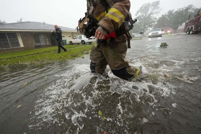 Morgan City firefighters respond to a home fire during Hurricane Francine in Morgan City, La., Wednesday, Sept. 11, 2024. (AP Photo/Gerald Herbert)