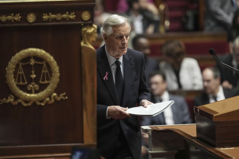 France's Prime Minister Michel Barnier arrives at stage to deliver a speech at the National Assembly, in Paris, Tuesday, Oct. 1, 2024. (AP Photo/Thibault Camus)